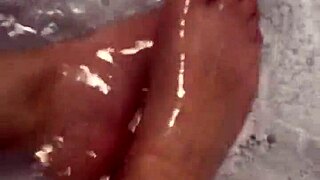 Hungarian babe takes off nylon and enjoys footjob in shower.