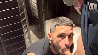 Gay men in bathrooms get handjobs.