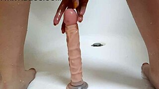 Teen babe trains her ass with big dildo in bath for stretching