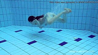 Roxalana cheh shows her shaved pussy underwater as a sexy redhead