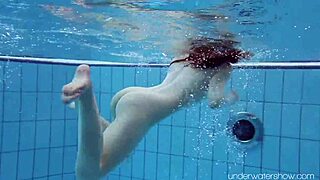 Roxalana cheh shows her shaved pussy underwater as a sexy redhead