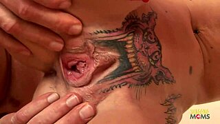 skinny blonde with pussy tattoo takes creampie on red couch. she rides hard in cowgirl style.