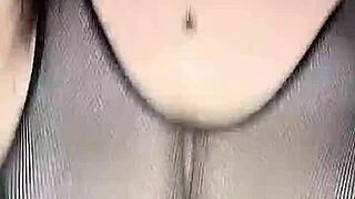 Man in stockings fucks woman's huge natural tits from above on mesh body.