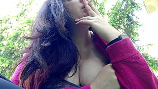 nicoletta is smoking in the public garden and flashing her big tits by pulling them out