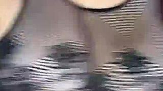 Man in stockings fucks woman's huge natural tits from above on mesh body.