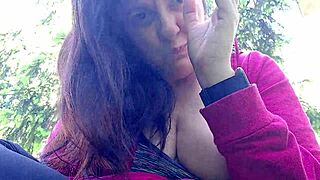 nicoletta is smoking in the public garden and flashing her big tits by pulling them out