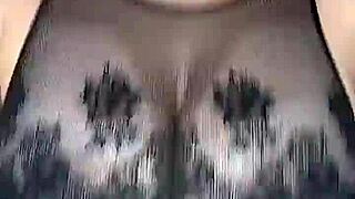 Man in stockings fucks woman's huge natural tits from above on mesh body.