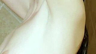 Skinny teen brunette freshens up in a steamy shower scene