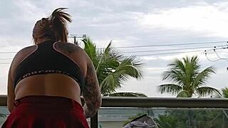 girl flashes her ass on the balcony in skirt