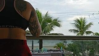 girl flashes her ass on the balcony in skirt
