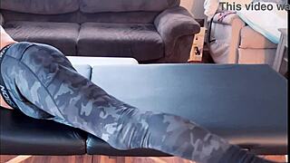 Bodybuilder stretches in leggings on massage table