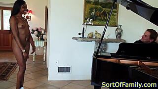 Black stepdaughter bent over for doggystyle by mature man near piano.