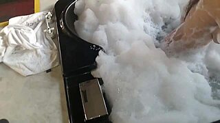 Spying on a brunette bathing, a guy in feminine clothing enters and they engage in intimate activities with her pear-shaped ass