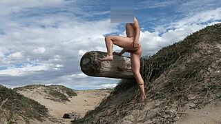 An athletic woman poses nude on the beach, teasing her cock before cumming in the plaza.