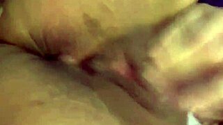 Tattooed woman teases her wet puffy pussy with toys.