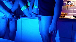 Wife sucks two cocks in threesome under neon lights.