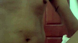 Latina brunette starts recording herself alone at home.