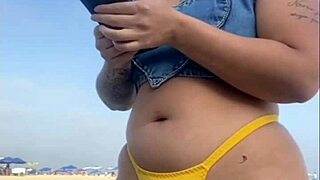 African woman flashes on beach