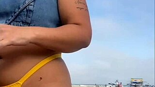 African woman flashes on beach