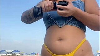 African woman flashes on beach