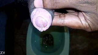 Boy takes a quick pee while the black man handles his own pissing moment outdoors.