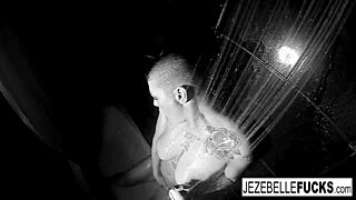 Brunette pornstar Jezebelle Bond strips nude and masturbates her big tits in a steamy shower solo.