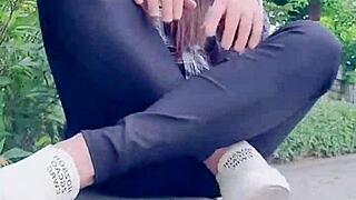 Chinese crossdressing ladyboy masturbates outdoors in stockings during midday urge.
