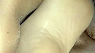She gives a homemade footjob while wearing sheer nylons
