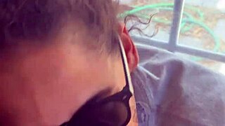 In a homemade setup, lightskin ebony slut gives blowjob to big black cock friend by the window and takes facial cumshot.