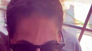 In a homemade setup, lightskin ebony slut gives blowjob to big black cock friend by the window and takes facial cumshot.