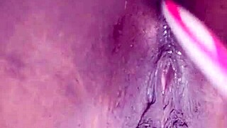 ebony performer inserts a brush into her anus for pleasure