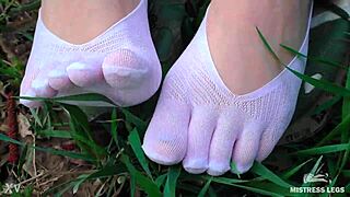 Goddess Feet in Cute White Socks and Jeans on Spring Grass Field