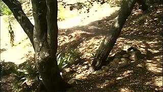 Let's try outdoor lesbian sex with strapon and fingering between trees in fishnets.