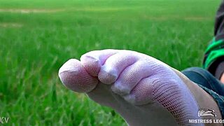 Goddess Feet in Cute White Socks and Jeans on Spring Grass Field