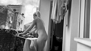 Naked chubby woman with big tits hangs laundry on balcony for neighbors to watch