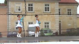 two nice majorettes practice routines together in the sunny park field