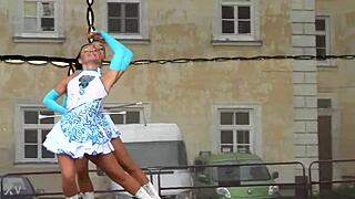 two nice majorettes practice routines together in the sunny park field