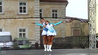 two nice majorettes practice routines together in the sunny park field