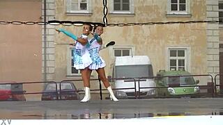 two nice majorettes practice routines together in the sunny park field