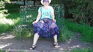 Hairy mature woman walks in see-through dress flashing beaver outdoors