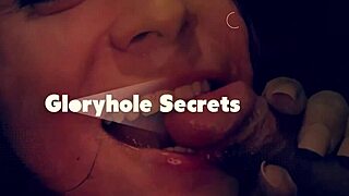 in the dim gloryhole booth, a tattooed redhead deepthroats cocks with sloppy passion