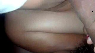 the wife wears a blindfold in the scene. she performs oral actions on him with focus.