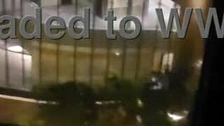 Petite amateur babe masturbating clit close up in public outdoor spot in front of hotel window to orgasm