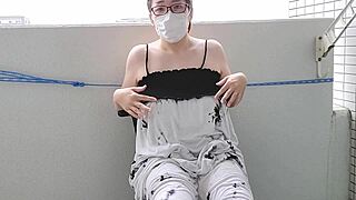 Japanese wife masturbates excitedly on balcony in bold solo action.
