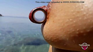 Nippleringlover enjoys hot pissing on a nude beach with pierced pussy wide open and huge pierced nipples