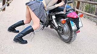 This Latina biker chick mounts her motorcycle outdoors and rides a dildo wildly in leather gear