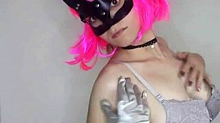 Moaning housewife in maid corset masturbates with dildo and mask.