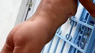 Mature blonde wanders nude through lush garden flashing shaved pussy in heels