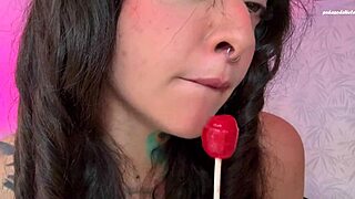 split tongue girl licks lollipop then shoves it deep in her hairy ass