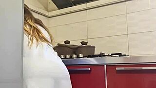 Sexy babe cleans stove then heats up with solo tit play